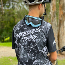Load image into Gallery viewer, Kai Pyyvaara wearing our short sleeve black camo jersey . Available in youth sizes and made in Australia from recycled plastic.